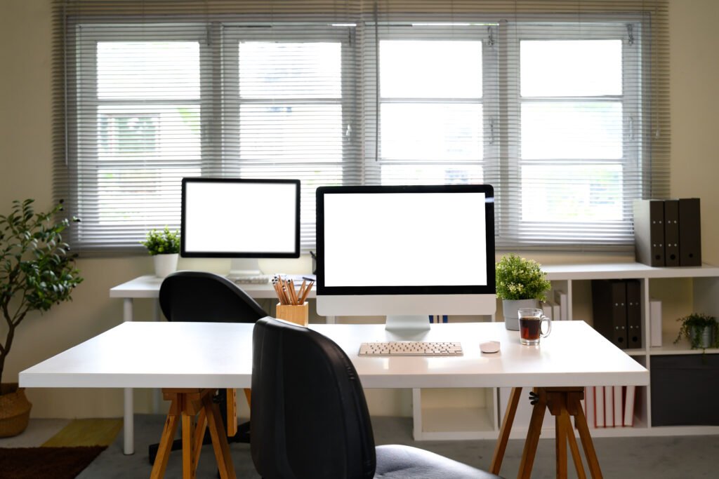 Home office workspace with desktop computers used for small business marketing and SEO