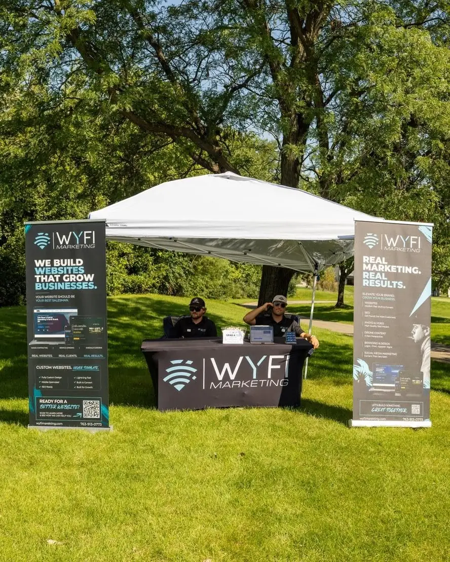 Wyfi Marketing sponsor booth at a Minnesota client golf tournament with branded banners